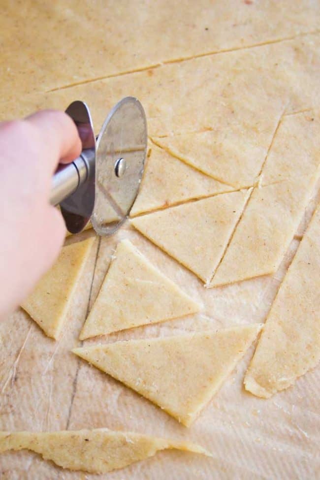 cutting almond flour into trangle shaped keto chips